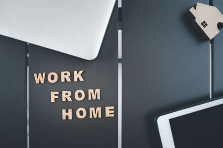 work from home word with home model on orange backgroundの写真素材