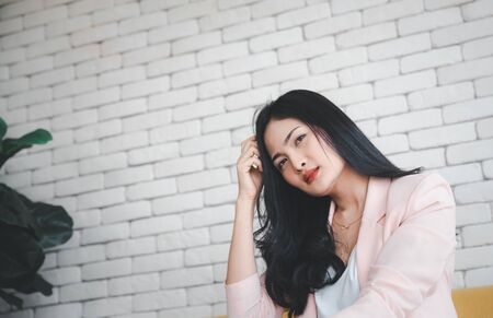 beautiful woman with hand on head and thinking face, emotional expression conceptの写真素材