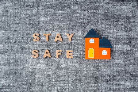 stay safe word with orange color home model on grey background, coronavirus prevention conceptの写真素材