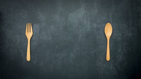 wooden spoon and fork on dark blue background with copy space, food and drink, dining conceptの写真素材