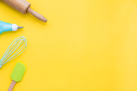 top view pastel tone baking utensils for bakery preparing on yellow background with copy space