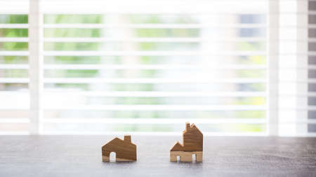 wooden home models with bamboo blind on background, investment and insurance conceptの写真素材
