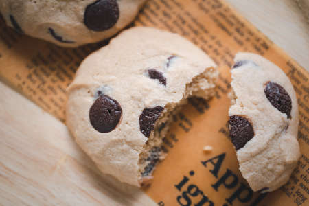 closeup cut chocolate chip cookie on wooden dishの写真素材