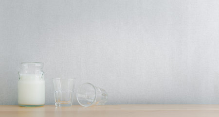 kitchenware and utensils decorated on wooden shelf or counter with white wall background and copy...