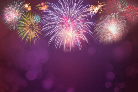colorful fireworks celebration on pink bokeh backgroundの写真素材