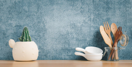 kitchenware and utensils decorated on wooden shelf or counter with blue wall background and copy space, home decorの写真素材