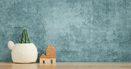 cactus pot and home model decorated on wooden shelf or counter with blue wall background and copy space, home decorの写真素材