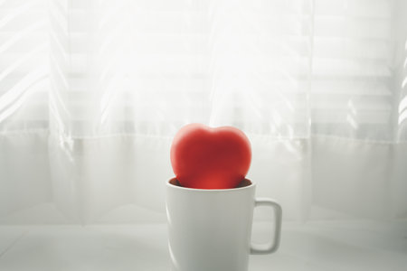 red rubber hearts in white mug with transparent curtain background, Valentine's day conceptの写真素材