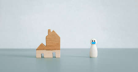wooden doll wearing mask outside home model, new normal for conceptの写真素材