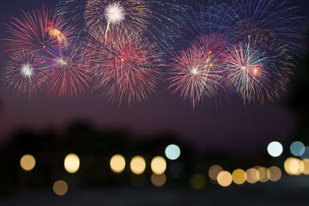 colorful fireworks above light bokeh backgroundの写真素材