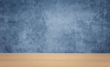 Light brown wood table top perspective with blue background for product displayの写真素材