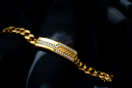 gold bracelet with diamond isolated on black background, fashion and design accessory
