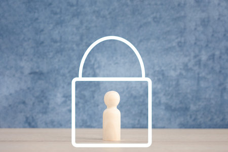 wooden doll inside lock icon, lockdown for prevention conceptの写真素材