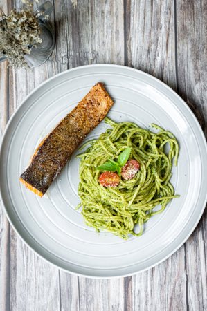 pesto spaghetti with salmon steak, healthy foodの写真素材