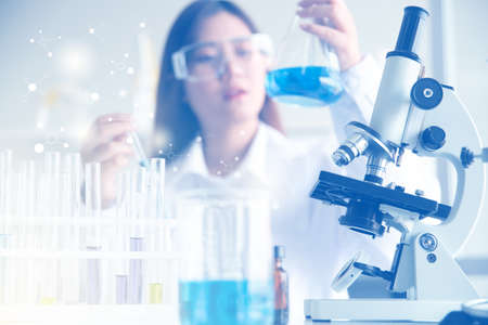 laboratory research and development concept by scientists with lab glassware, experimental chemical and drugの写真素材