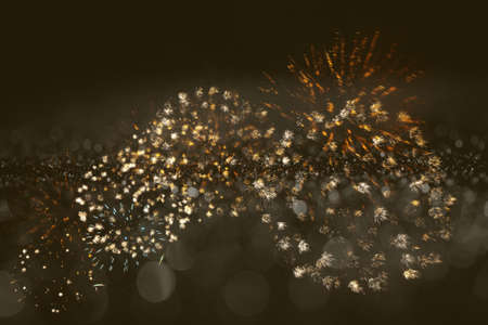 colorful fireworks on dark yellow bokeh background, celebration conceptの写真素材