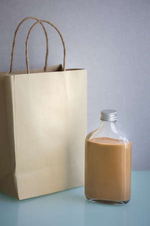 bottle of milk tea with paper bag without label, product delivery conceptの写真素材
