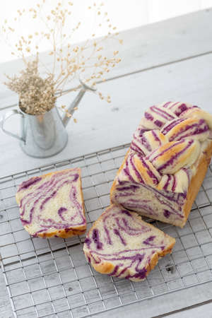 fresh baked purple sweet potato bread loaf on rack, homemade bakeの写真素材