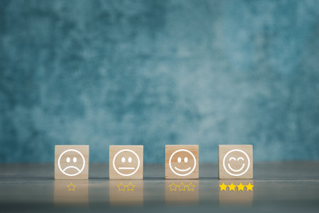 various emotion faces on wooden cubes arranged on table for satisfaction survey, mental health...