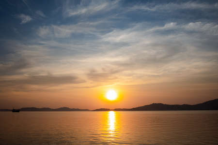beautiful sunset view above sea with mountain and nice skyの写真素材