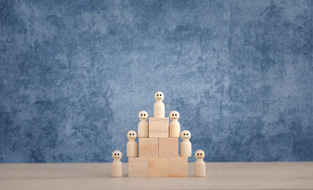 happy wooden doll team arranged on wood block step, teamwork and successful conceptの写真素材