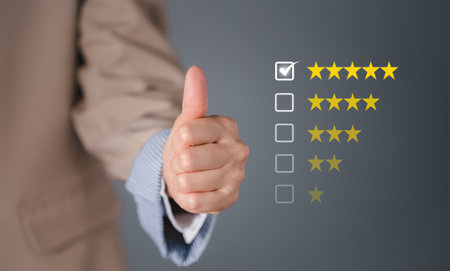 closeup businesswoman thumb up with checked box on 5 stars rating, satisfactory survey conceptの写真素材