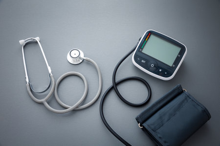 stethoscope with blood pressure measurement machine on dark grey background, health conceptの写真素材