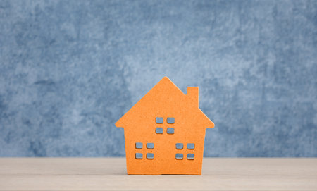 isolated orange wood home model on blue backgroundの写真素材