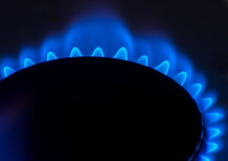 gas burning on household stove against dark backgroundの写真素材