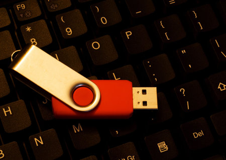 Red USB stick on a dark computer keyboard
