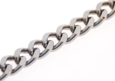 A Piece of chain on a white background with focus on the middle linksの写真素材
