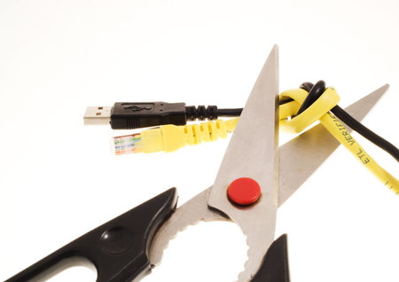 Pair of scissors about to cut two cables knotted together