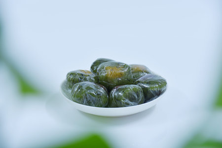A plate of Qingtuan stuffed with egg yolk and dried meat floss. Traditional seasonal Chinese...