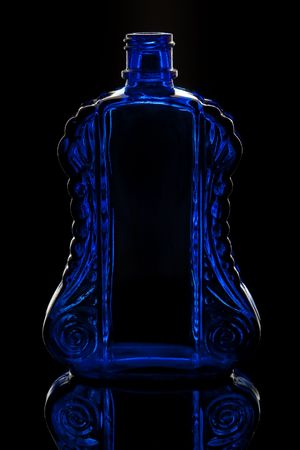 Blue Glass Bottle on black backgroundの写真素材