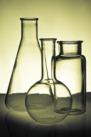 Backlit Chemistry Flasks and Glassware on a Tableの写真素材