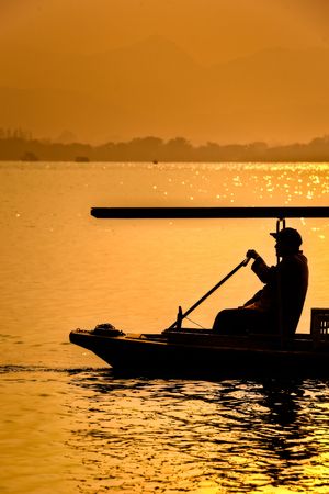 Rowing traditional boat at West Lake in Chinaの写真素材