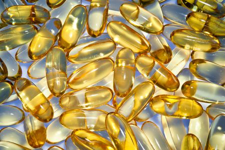 Yellow medical pills on Blue back groundの写真素材
