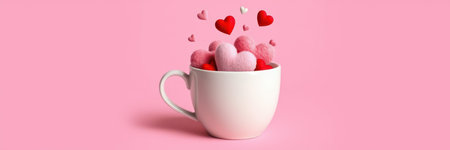 Pink and red hearts, seemingly made of felt, fill a white mug to overflowingの写真素材