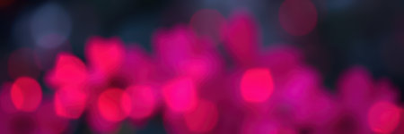 Vivid pink bokeh lights create a magical atmosphere during an evening celebration outdoors in a vibrant park settingの素材