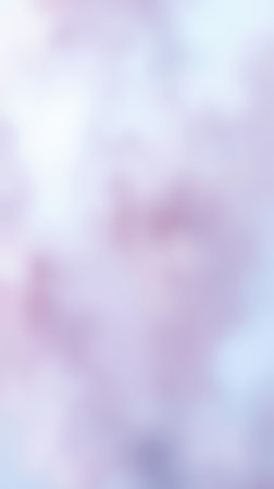 Soft pastel clouds fill the sky during a serene sunset in a tranquil outdoor setting near a riverbankの素材