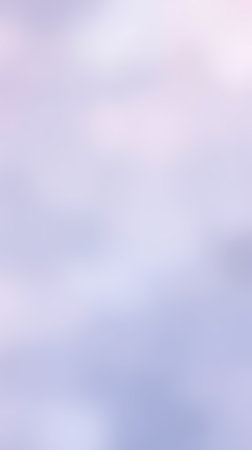 Soft gray clouds float gently across the sky at twilight, creating a serene atmosphere with hints of colorの素材