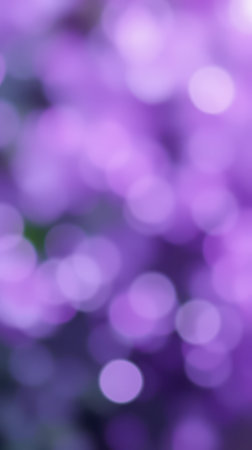 Beautiful purple bokeh lights create a dreamy atmosphere in a garden during springtimeの素材