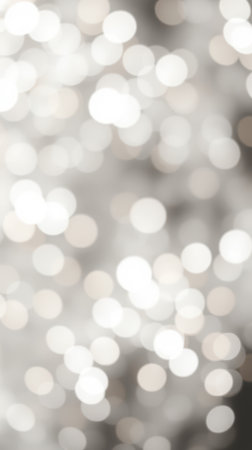 Light reflections create a sparkling background in a soft, blurred composition of bright, circular patternsの素材