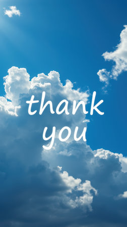 Message of gratitude written in cloud formations under a bright blue sky during daylightの素材