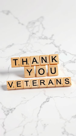 Wooden blocks spell out a heartfelt message of gratitude for veterans on a marble backgroundの素材