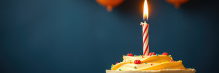Celebration with a birthday cake featuring a single candle and colorful frosting, perfect for a joyful occasionの素材