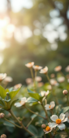 Beautiful blooming flowers in soft evening light surrounded by lush greenery in a serene garden settingの素材
