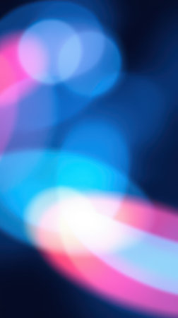 Colorful abstract lights create a vibrant display of motion and energy in a dark settingの素材