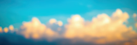 Beautiful sunset clouds reflecting warm colors over a serene blue sky in the evening lightの素材