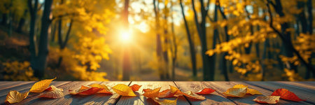 Autumn leaves scattered on rustic wooden surface with glowing sunset in a serene forest settingの素材